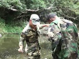 Two military lads resting by the river